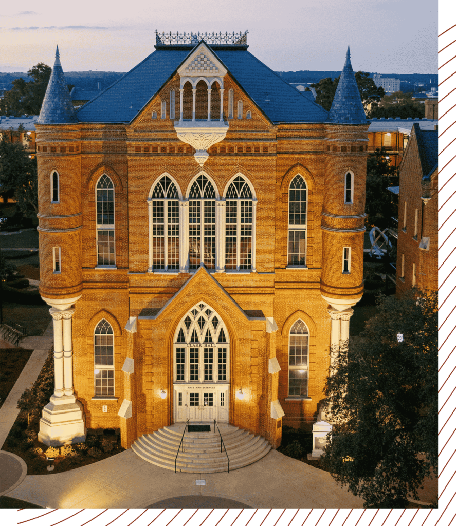 An academic building illuminated at sunset.