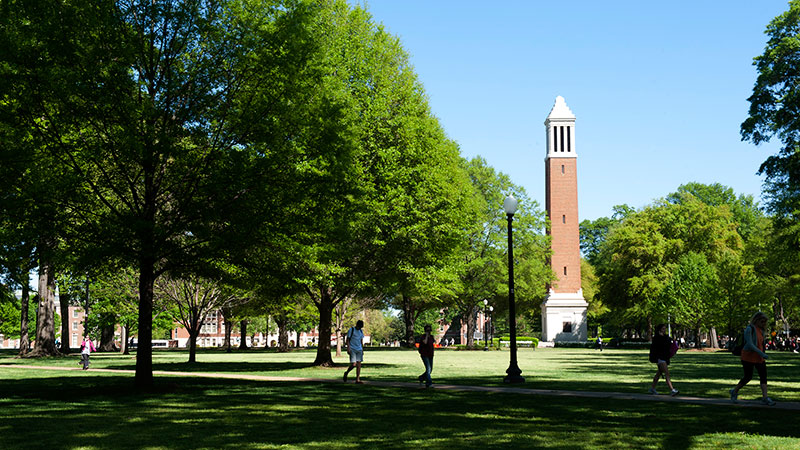 The Quad in Spring with two students walking by.